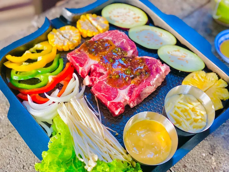 Khay thịt nướng ướp sẵn kèm bắp ngọt và rau củ nhiều màu